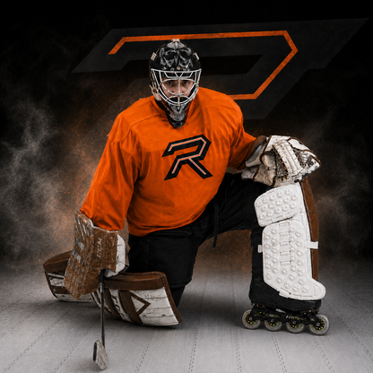 Hockey goalie in orange jersey with 'R' logo on a dark background